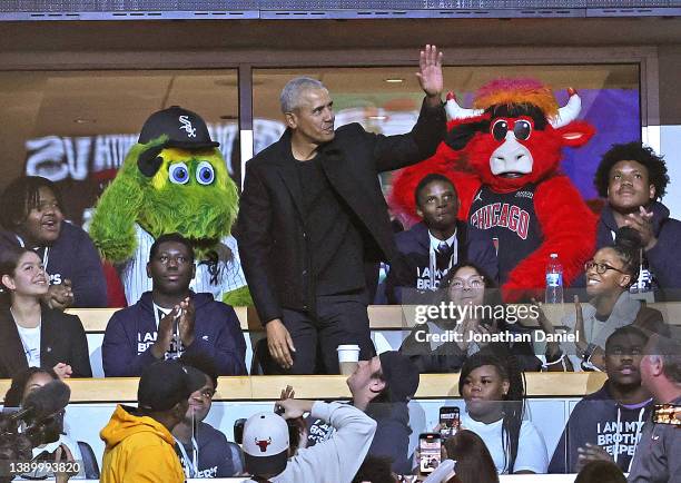 Former President Barak Obama waves to the crowd as he takes in a game at the United Center between the Chicago Bulls and the Boston Celtics on April...