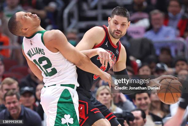 Nikola Vucevic of the Chicago Bulls moves against Grant Williams of the Boston Celtics after a collision at the United Center on April 06, 2022 in...