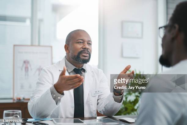 Shot of a mature doctor having a consultation with his patient