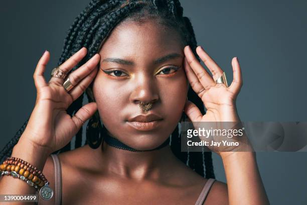 studio shot of a trendy young woman posing against a grey background - piercing stock pictures, royalty-free photos & images