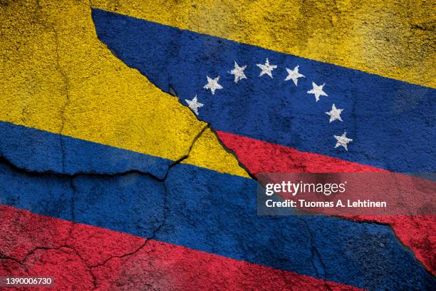 full frame photo of weathered flags of colombia and venezuela painted on a cracked wall. - venezuela flag stock pictures, royalty-free photos & images