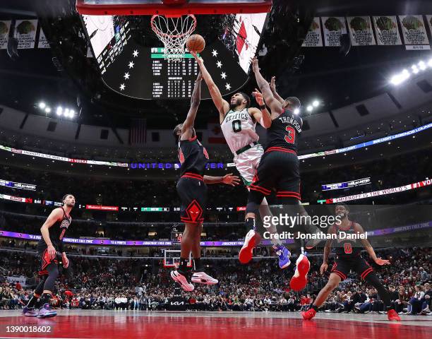 Jayson Tatum of the Boston Celtics shoots between Patrick Williams and Tristan Thompson of the Chicago Bulls at the United Center on April 06, 2022...