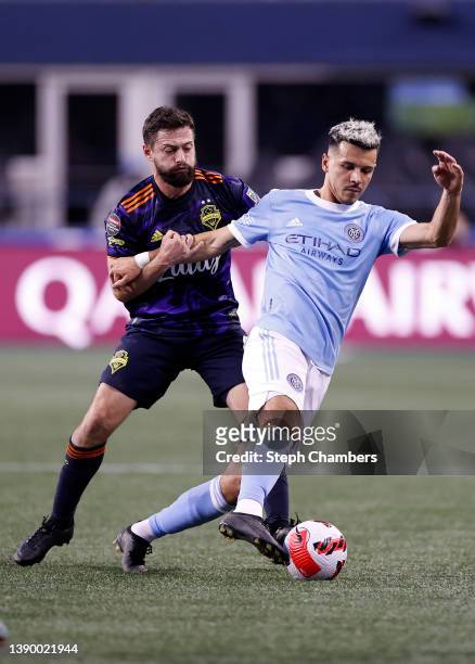 João Paulo of Seattle Sounders defends Alfredo Morales of New York City in the first half during the CONCACAF Champions League Semifinals at Lumen...