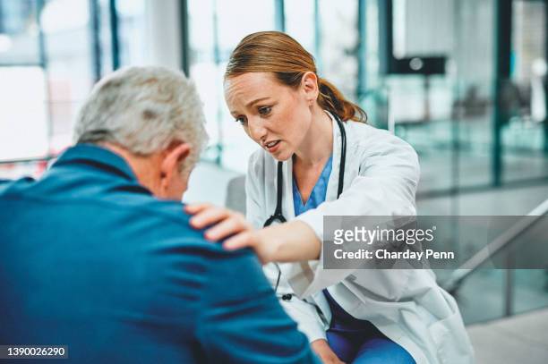 shot of a young doctor having a consultation with her elderly patient - sad nurse stock pictures, royalty-free photos & images