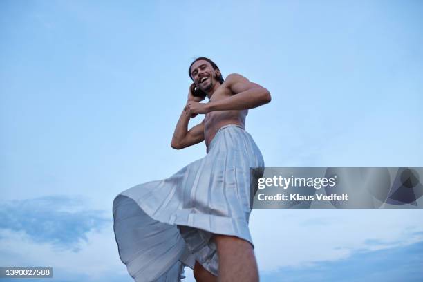 smiling ballet dancer in skirt standing against sky - long skirt stock pictures, royalty-free photos & images