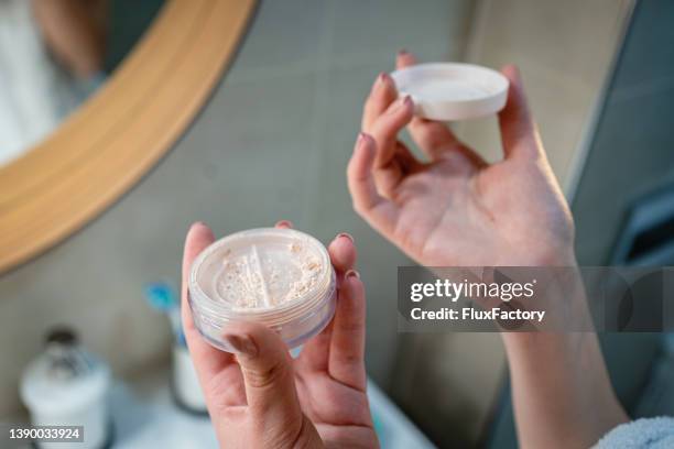 unrecognizable young woman holding the face powder - poder stock pictures, royalty-free photos & images