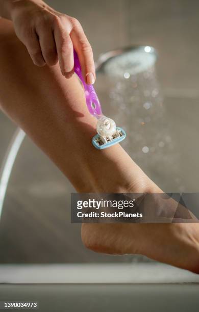close up of unrecognizable woman shaving her leg - pointed foot stock pictures, royalty-free photos & images