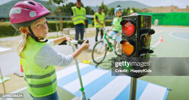 girl looking road signal symbol - yellow light stock pictures, royalty-free photos & images