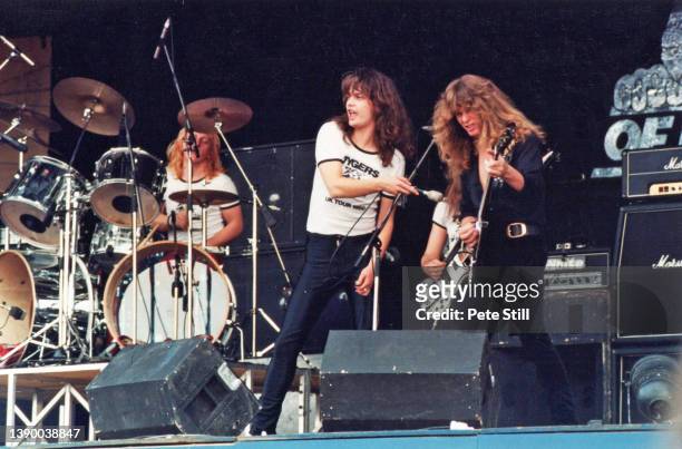 Drummer Brian Dick, Vocalist Jess Cox, and guitarist John Sykes of British heavy metal band Tygers of Pan Tang perform on stage at The Reading...