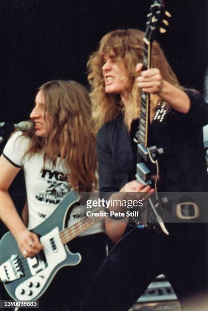 Bassist Richard 'Rocky' Laws and guitarist John Sykes of British heavy metal band Tygers of Pan Tang perform on stage at The Reading Festival on...