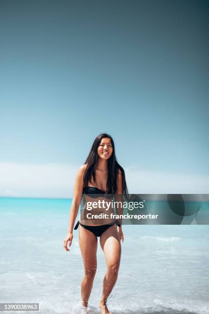 asian woman running on the beach - weight loss journey stock pictures, royalty-free photos & images