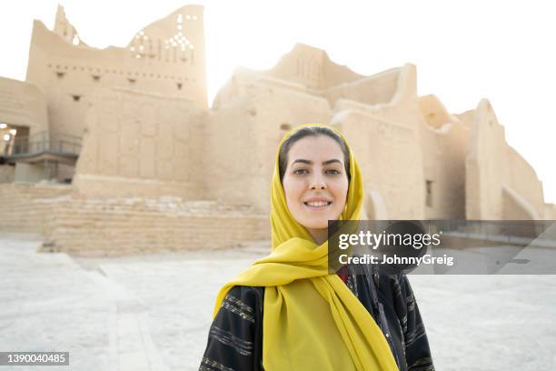 portrait of mid 30s tourist visiting at-turaif near riyadh - saudi arabia national day stock pictures, royalty-free photos & images
