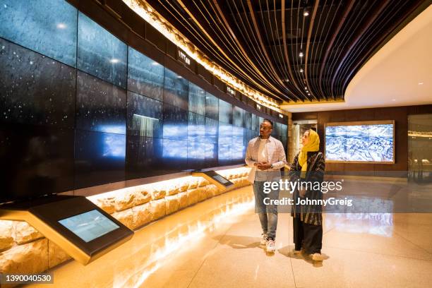 couple enjoying visual history in at-turaif visitor’s centre - er riad stock pictures, royalty-free photos & images