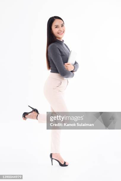 young businesswoman holding laptop, smiling, portrait - pleased face laptop stock pictures, royalty-free photos & images