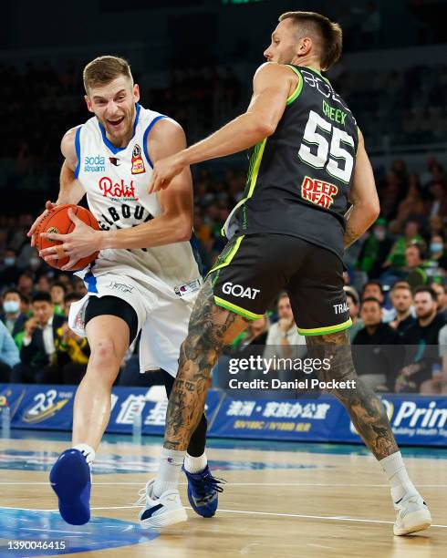 Jack White of United is fouled by Mitchell Creek of the Phoenix during the round 19 NBL match between South East Melbourne Phoenix and Melbourne...