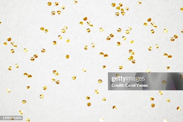 golden confetti in white bright background - glitter falling stock pictures, royalty-free photos & images