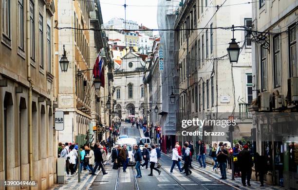 pedestrians crossing the road in lisbon - portugal road stock pictures, royalty-free photos & images