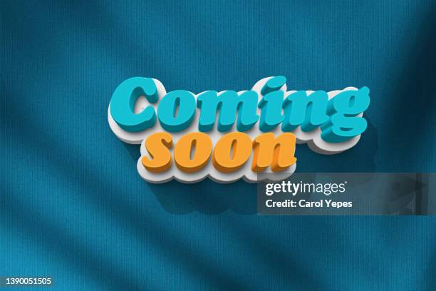 "coming soon" message in 3d letters,blue textile background - returning soon stock pictures, royalty-free photos & images