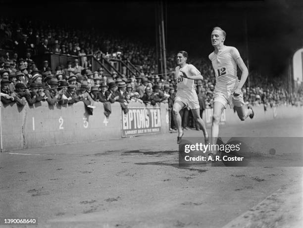 English middle distance runner H B Stallard crosses the finish line in first place to win the Men's 880 yards event at the Amateur Athletics...