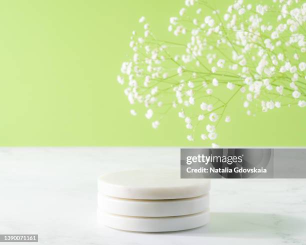 marble coaster stack on light green background. minimalistic concept. modern three dimensional design - coaster stock pictures, royalty-free photos & images