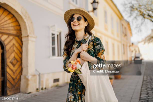 woman shopping flowers, fruits and vegetables with reusable cotton eco produce bag. zero waste lifestyle concept - plastic free stock pictures, royalty-free photos & images