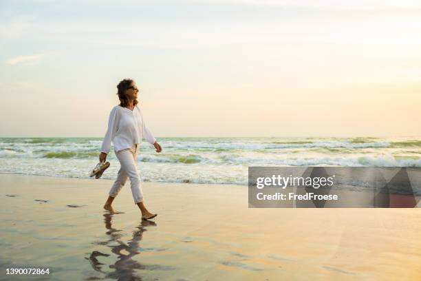 happy carefree woman on beach - grass hut on beach stock pictures, royalty-free photos & images