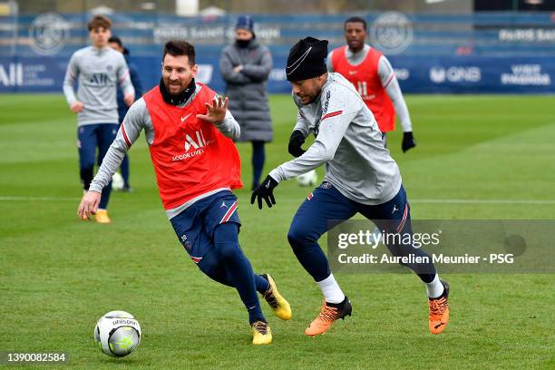 Neymar Jr and Leo Messi fight for possession during a Paris Saint-Germain training session at Ooredoo Center on April 07, 2022 in Paris, France.