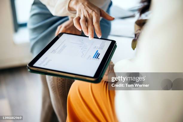 close up of business colleagues using digital tablet together - brainstorming stock photos et images de collection