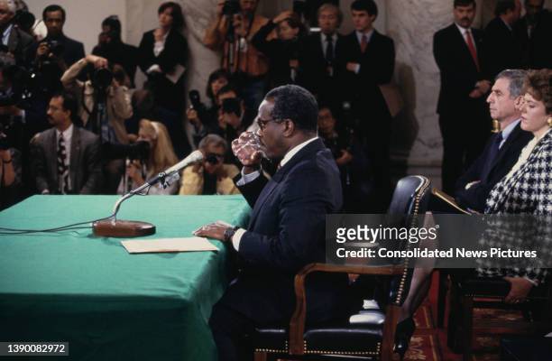 American lawyer and US Supreme Court nominee Clarence Thomas testifies before the confirmation hearings, watched by American politician Richard Lugar...