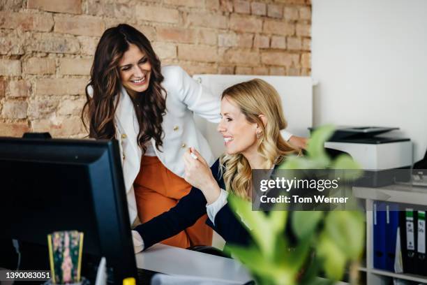 business owner laughing with colleague in office together - friendly small business talking stock pictures, royalty-free photos & images