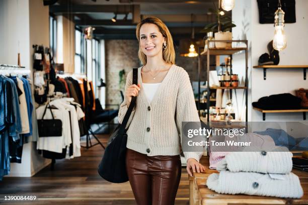portrait of glamorous customer in fashionable clothing store - leather trousers stock pictures, royalty-free photos & images
