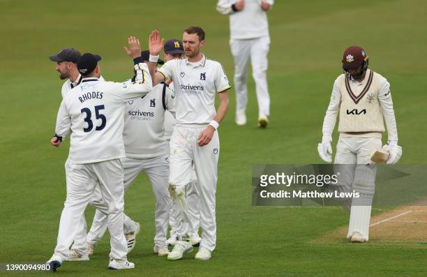 Oliver Hannon-Dalby of Warwickshire is congratulated on the wicket of Ryan Patel of Surrey, after he was caught by Michael Burgess during the LV=...