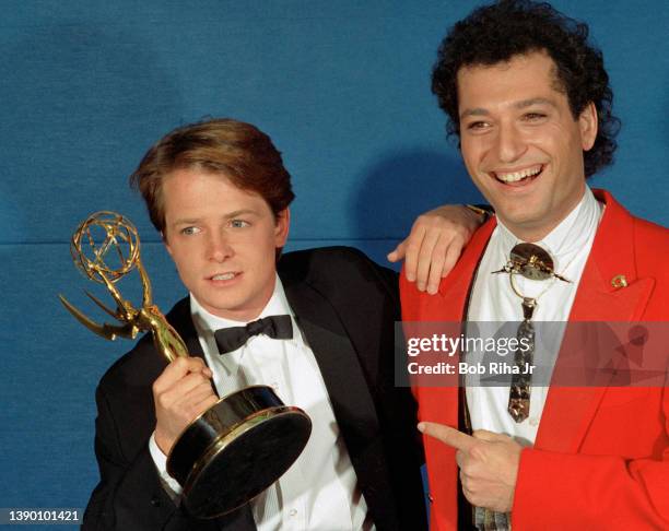 Winner Michael J. Fox with comedian Howie Mandel backstage at the Emmy Awards Show, September 21, 1986 in Pasadena, California.