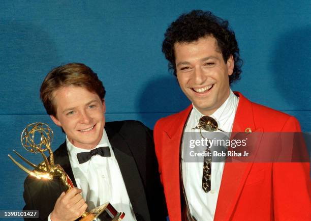 Winner Michael J. Fox with comedian Howie Mandel backstage at the Emmy Awards Show, September 21, 1986 in Pasadena, California.
