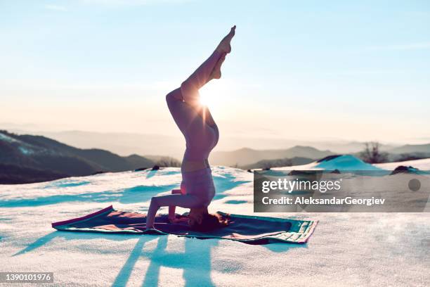 twisted root headstand by yogini during sunset - kimono winter stock pictures, royalty-free photos & images