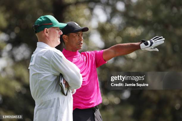 Tiger Woods and caddie Joe LaCava line up a shot from the second hole during the first round of the Masters at Augusta National Golf Club on April...