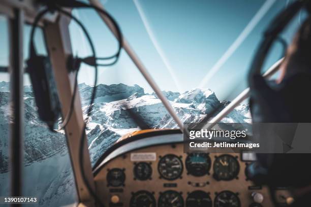 cockpit view of a historic airplane flying into the mountains - small plane stock pictures, royalty-free photos & images