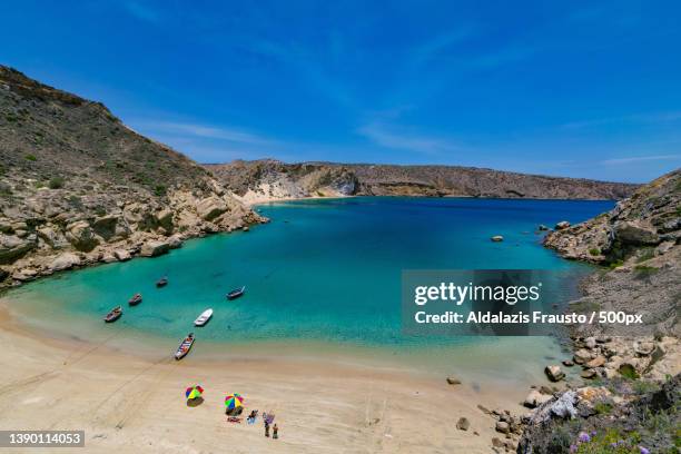 high angle view of boats moored at beach against blue sky,benguela,angola - angola stock pictures, royalty-free photos & images