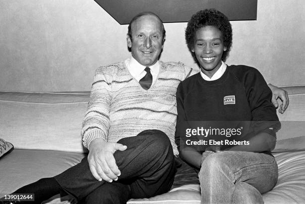 Clive Davis and Whitney Houston photographed at the signing of her contract with Arista Records at the Arista Studio in New York, on April 10, 1983.