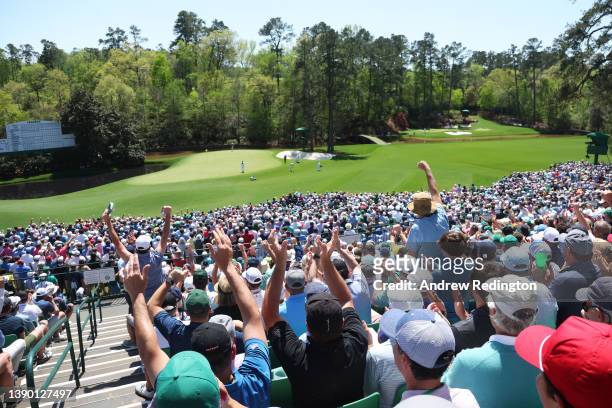 Fans react to a chip in by Kevin Kisner on the 11th green during the first round of the Masters at Augusta National Golf Club on April 07, 2022 in...
