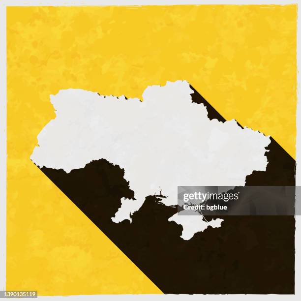ukraine map with long shadow on textured yellow background - ukraine map stock illustrations
