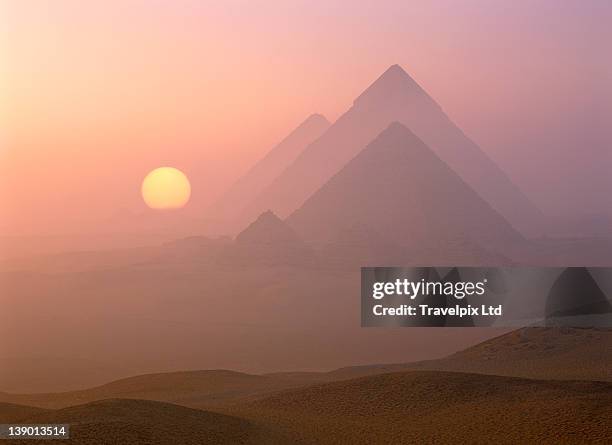 the pyramids viewed at sunrise, giza, egypt - piramidevorm stockfoto's en -beelden