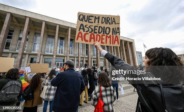 Demonstrators hoist anti harassment signs as students gather in front of the Rectorate of the Universidade de Lisboa to protest "against machismo and...