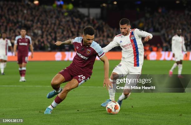 Ryan Fredericks of West Ham United is challenged by Houssem Aouar of Olympique Lyonnais during the UEFA Europa League Quarter Final Leg One match...