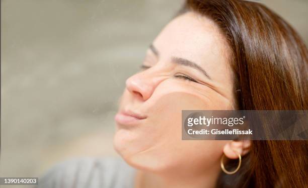 woman lying with her face pressed against glass - funny face woman stock pictures, royalty-free photos & images