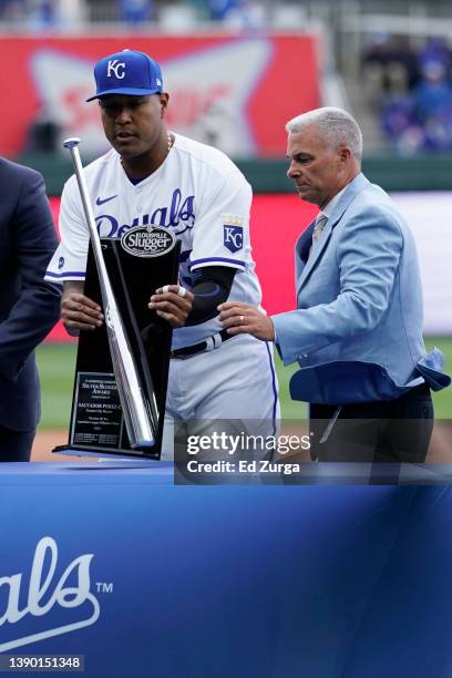 Salvador Perez of the Kansas City Royals accepts his 2021 Louisville Slugger Silver Slugger award as general manager Dayton Moore looks on prior to a...