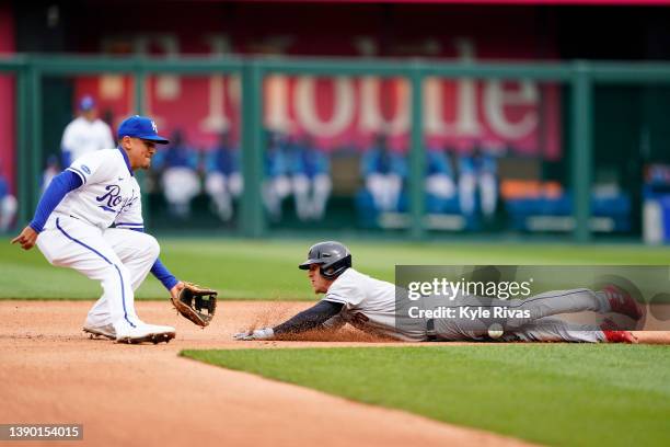 Myles Straw of the Cleveland Guardians slides safely past the tag from Nicky Lopez of the Kansas City Royals in the third inning during Opening Day...