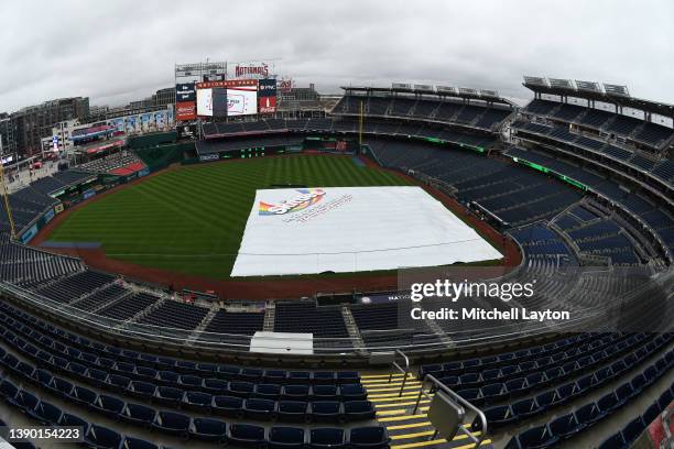 General view of the field covered with the rain tarp before the game between the New York Mets and the Washington Nationals on Opening Day at the...