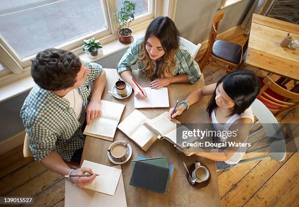 students sitting at table studying together. - long table stock pictures, royalty-free photos & images