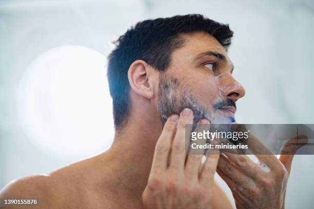 handsome man washing his face in the bathroom - pelo facial imagens e fotografias de stock
